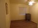Bedroom with hardwood floors, ceiling fan, window with blinds, and floor air conditioning unit at 5889 Garden Ln # H4, Bradenton, FL 34207