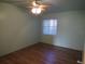 Light green bedroom featuring a ceiling fan, window, and hardwood floors, perfect for relaxation and comfort at 5889 Garden Ln # H4, Bradenton, FL 34207