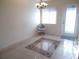 Bright dining area features tile flooring, a modern chandelier, and a glass door that offers plenty of natural light at 5889 Garden Ln # H4, Bradenton, FL 34207