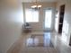 Bright dining area features tile flooring, a modern chandelier, and a glass door that offers plenty of natural light at 5889 Garden Ln # H4, Bradenton, FL 34207