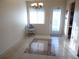 Dining room with tiled floor, modern light fixture, chair, and a glass paned exterior door at 5889 Garden Ln # H4, Bradenton, FL 34207