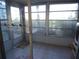 Enclosed porch with vinyl windows, tiled floors, and doorway to outside at 5889 Garden Ln # H4, Bradenton, FL 34207