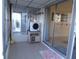Enclosed porch with tiled flooring, storage, and access to living room and exterior at 5889 Garden Ln # H4, Bradenton, FL 34207