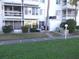 Exterior of condo building with lush landscaping and well-maintained lawn at 5889 Garden Ln # H4, Bradenton, FL 34207