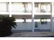 Exterior view of a two-story condo building with clean white facade and well-maintained landscaping at 5889 Garden Ln # H4, Bradenton, FL 34207