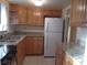 Functional kitchen featuring granite countertops, stainless steel sink and ample cabinet storage at 5889 Garden Ln # H4, Bradenton, FL 34207