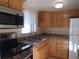 Well-maintained kitchen with wood cabinets, granite countertops, stainless steel microwave, and modern appliances at 5889 Garden Ln # H4, Bradenton, FL 34207