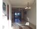Open-concept living room features tile floors, a ceiling fan, and a sliding glass door to the outside patio at 5889 Garden Ln # H4, Bradenton, FL 34207