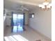 Open-concept living room featuring tile floors, a ceiling fan, and a sliding glass door to the outside patio at 5889 Garden Ln # H4, Bradenton, FL 34207