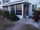 Enclosed condo porch with exterior access and landscaping at 5889 Garden Ln # H4, Bradenton, FL 34207