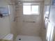 Shower features safety bars, built-in shelving and a window for plenty of natural light at 5889 Garden Ln # H4, Bradenton, FL 34207