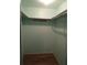 Empty walk-in closet featuring hardwood floors and shelving, providing ample storage space for your wardrobe at 5889 Garden Ln # H4, Bradenton, FL 34207