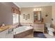 Bright bathroom featuring a soaking tub, a window, a neutral vanity, and tiled floors at 6101 34Th W St # 33D, Bradenton, FL 34210