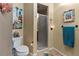 Bathroom featuring a toilet, glass enclosed shower, and decorative accents at 6101 34Th W St # 33D, Bradenton, FL 34210