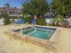 Inviting community hot tub featuring a tiled trim, handrails, and nearby lounge chairs for relaxation at 6101 34Th W St # 33D, Bradenton, FL 34210