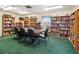 Well-stocked library featuring floor-to-ceiling bookshelves and a large table with chairs at 6101 34Th W St # 33D, Bradenton, FL 34210