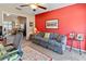 Sitting room with red accent wall, comfortable couch, and pass through to main living area at 6101 34Th W St # 33D, Bradenton, FL 34210