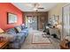 Sitting room with a red accent wall, carpeted floor, and sliding glass doors to the outside balcony at 6101 34Th W St # 33D, Bradenton, FL 34210