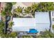 Aerial view of lovely home with lush tropical landscaping and a private backyard pool at 6201 Holmes Blvd, Holmes Beach, FL 34217