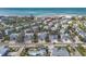 Aerial view of a charming neighborhood with homes near the beach, surrounded by lush greenery and palm trees at 6201 Holmes Blvd, Holmes Beach, FL 34217