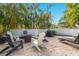 Backyard patio and deck with ample seating, grill and lush landscaping at 6201 Holmes Blvd, Holmes Beach, FL 34217