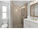 Modern bathroom with a glass-enclosed shower, neutral tile, and vanity at 6201 Holmes Blvd, Holmes Beach, FL 34217