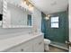 Chic bathroom featuring a white vanity, decorative mirror, and a glass shower at 6201 Holmes Blvd, Holmes Beach, FL 34217