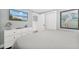 Comfortable bedroom featuring coastal decor, a mounted TV, and a dresser at 6201 Holmes Blvd, Holmes Beach, FL 34217