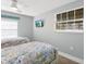 Well-lit bedroom with twin beds and a TV, decorated with a coastal theme at 6201 Holmes Blvd, Holmes Beach, FL 34217