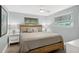Calm, well-lit bedroom with queen bed, ceiling fan, and dual bedside tables at 6201 Holmes Blvd, Holmes Beach, FL 34217