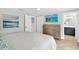 Bright bedroom featuring a mounted TV, ensuite bathroom and neutral decor at 6201 Holmes Blvd, Holmes Beach, FL 34217