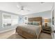 Cozy bedroom with a ceiling fan, natural light, and comfortable wooden bed frame at 6201 Holmes Blvd, Holmes Beach, FL 34217