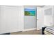 Bedroom showcasing a large closet, television, and access to another room at 6201 Holmes Blvd, Holmes Beach, FL 34217