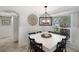 Bright dining room with square table, and decorative wall clock at 6201 Holmes Blvd, Holmes Beach, FL 34217
