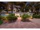 Inviting front entrance with brick walkway, lush tropical landscaping, and a charming single-story home at 6201 Holmes Blvd, Holmes Beach, FL 34217