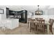 Modern kitchen and dining area with stainless steel appliances and stylish light fixtures at 6201 Holmes Blvd, Holmes Beach, FL 34217