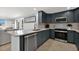 Bright kitchen with stone countertops, stainless appliances, and sleek dark-blue cabinetry at 6201 Holmes Blvd, Holmes Beach, FL 34217