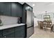 Modern kitchen with stainless steel refrigerator, dark cabinets and white backsplash at 6201 Holmes Blvd, Holmes Beach, FL 34217