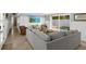 Cozy living room featuring comfortable seating, a mounted TV, and access to the pool area at 6201 Holmes Blvd, Holmes Beach, FL 34217