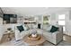 Cozy living room with comfortable sofa, patterned pillows, and round wooden coffee table at 6201 Holmes Blvd, Holmes Beach, FL 34217