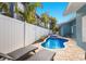 A beautiful kidney-shaped pool is surrounded by brick pavers and lounge chairs, perfect for relaxation at 6201 Holmes Blvd, Holmes Beach, FL 34217