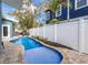 Private pool area with a paver patio, surrounded by tropical landscaping at 6201 Holmes Blvd, Holmes Beach, FL 34217