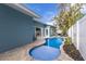 Backyard view of the pool featuring a beautiful blue tone and patio at 6201 Holmes Blvd, Holmes Beach, FL 34217