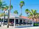 Vibrant outdoor restaurant with a charming patio and lush greenery, perfect for enjoying waterfront dining at 6201 Holmes Blvd, Holmes Beach, FL 34217