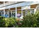 Charming retail storefront featuring unique local shops and boutiques along a tree-lined street; Anna Maria Olive Oil Outpost at 6201 Holmes Blvd, Holmes Beach, FL 34217
