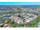 Scenic aerial view of a residential community with a mix of home styles surrounding a tranquil lake at 6911 Stetson Street Cir, Sarasota, FL 34243