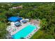 Aerial view of a beautiful community pool with clubhouse, playground, and lush landscaping at 6911 Stetson Street Cir, Sarasota, FL 34243