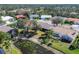 Community aerial view showing houses near a small lake with lily pads and greenery at 6911 Stetson Street Cir, Sarasota, FL 34243