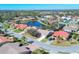 Overhead view of neighborhood homes with solar panels, surrounded by ponds and greenery at 6911 Stetson Street Cir, Sarasota, FL 34243