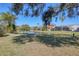 Scenic backyard offering serene views of the lake and lush landscaping at 6911 Stetson Street Cir, Sarasota, FL 34243